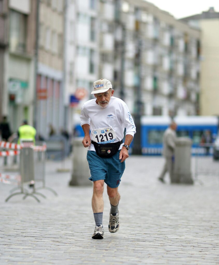 Senior male runner in a city marathon, showcasing determination and fitness.